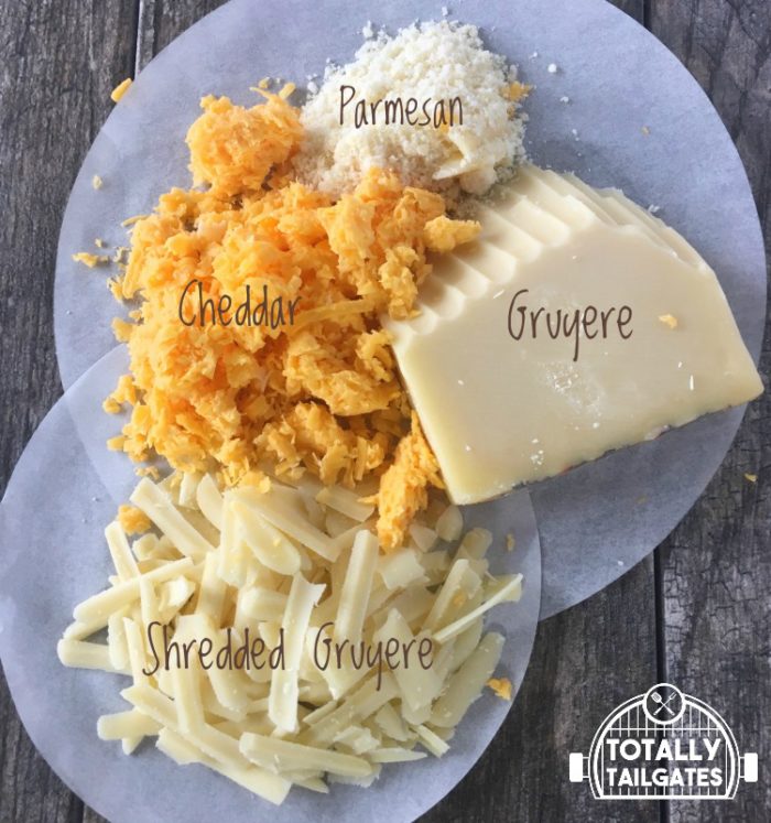 grated cheddar, Gruyere, and Parmesan cheese for lobster mac and cheese on parchment paper